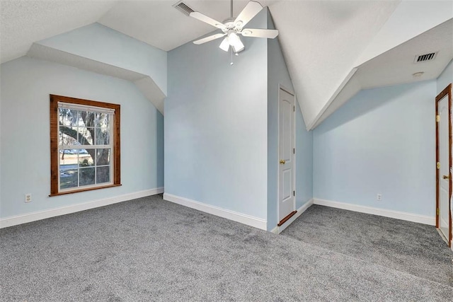 additional living space with lofted ceiling, visible vents, and carpet flooring