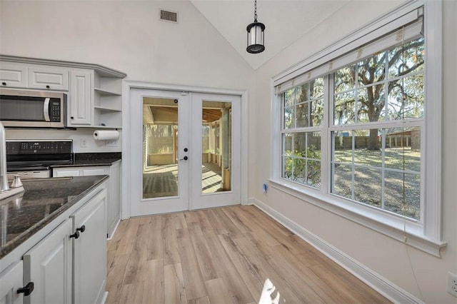 kitchen featuring open shelves, stainless steel microwave, electric range oven, light wood-style floors, and white cabinets