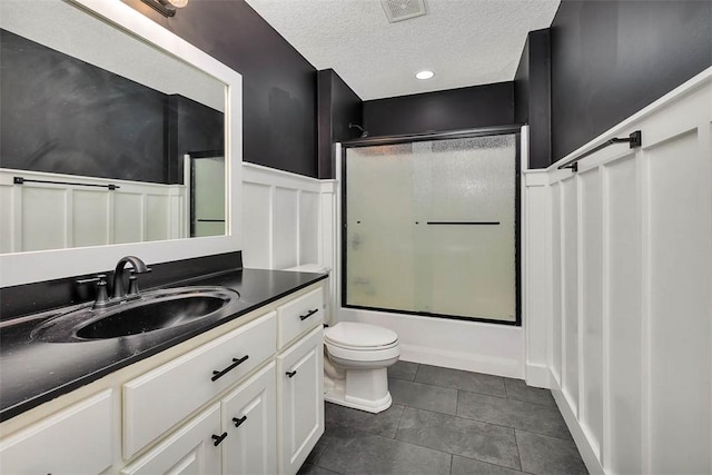 bathroom featuring visible vents, toilet, tile patterned floors, a textured ceiling, and vanity