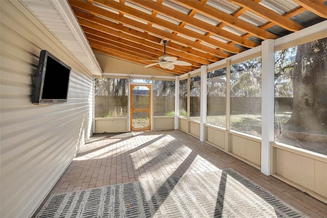 unfurnished sunroom with vaulted ceiling and a ceiling fan