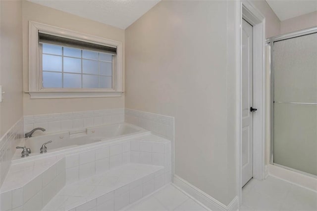 bathroom featuring a shower stall, baseboards, and a bath