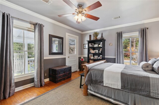 bedroom with wood-type flooring, ceiling fan, and crown molding