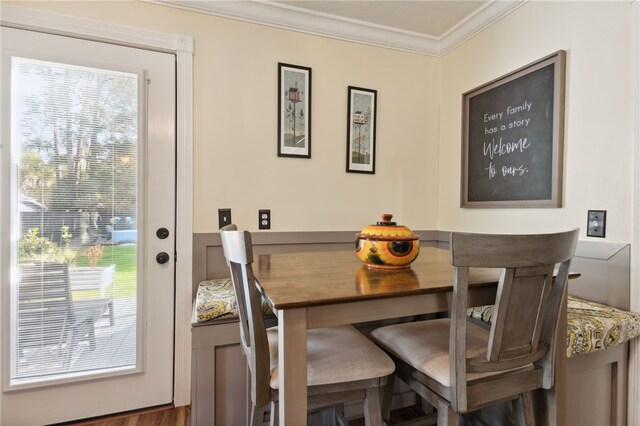 dining space featuring crown molding and dark hardwood / wood-style floors