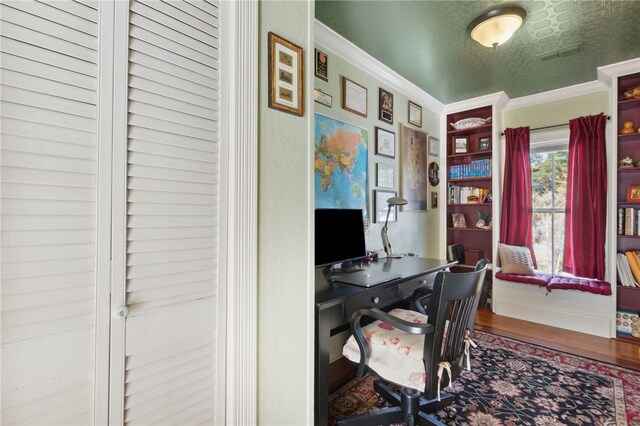 home office featuring crown molding, hardwood / wood-style floors, and a textured ceiling