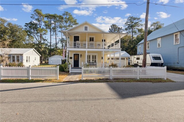 view of front of house featuring a balcony, covered porch, an outdoor structure, and a garage