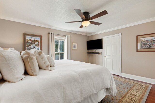 bedroom featuring ornamental molding, ceiling fan, and dark wood-type flooring