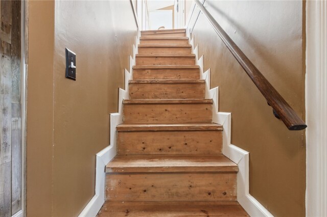 staircase with hardwood / wood-style floors