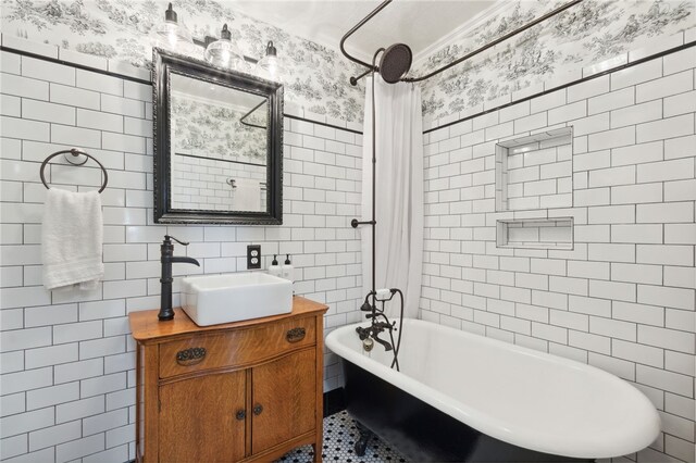 bathroom with shower / tub combo, vanity, and tile walls