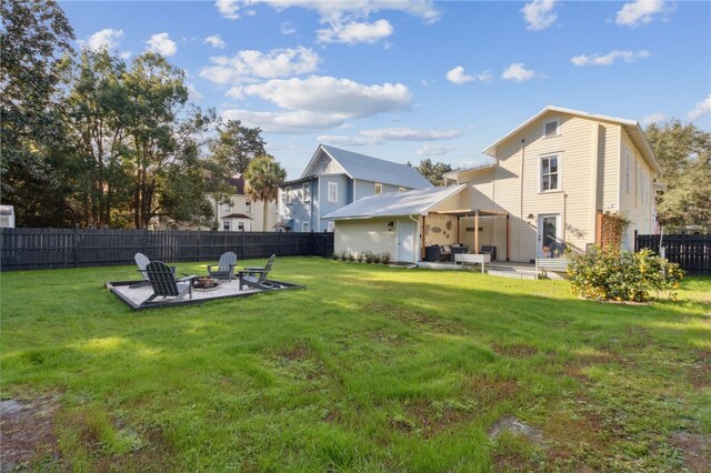 view of yard featuring an outdoor fire pit and a patio