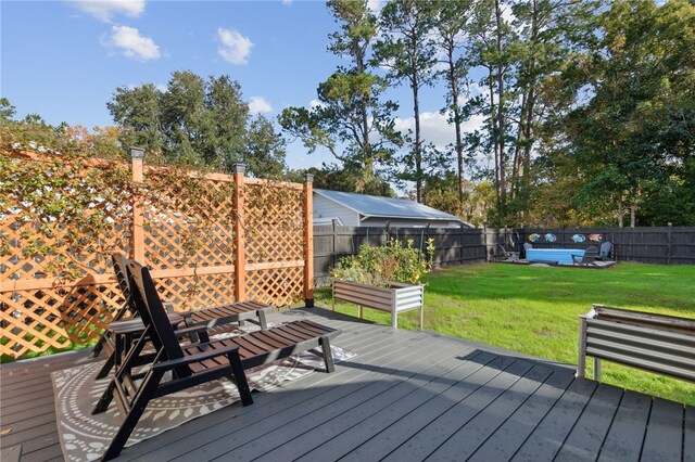 wooden deck featuring a lawn