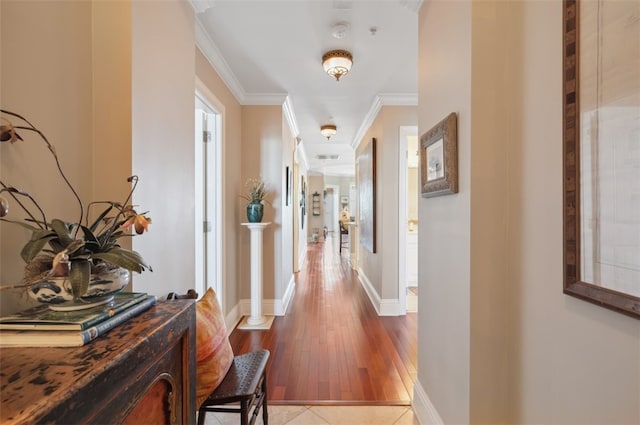 hallway featuring ornamental molding and light wood-type flooring