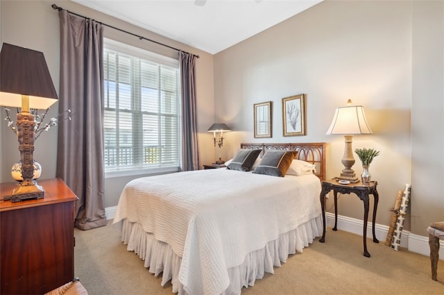 bedroom featuring light carpet, multiple windows, and lofted ceiling