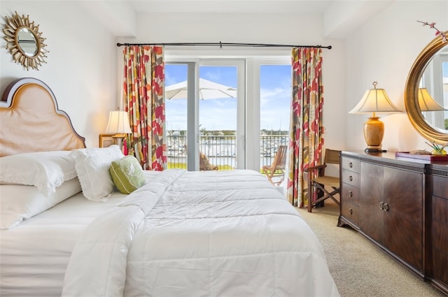 bedroom with access to exterior and light colored carpet