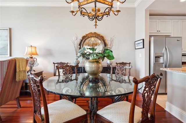 20 Waterfront Dr Unit 322, Saint Simons Island, GA 31522 - dining space featuring a chandelier, crown molding, wood finished floors, and baseboards