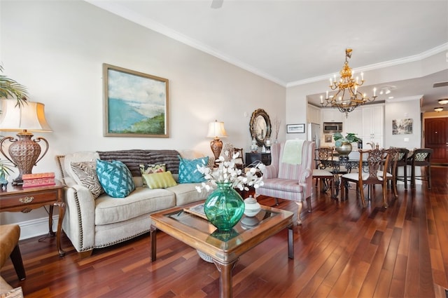 living room featuring dark hardwood / wood-style floors, an inviting chandelier, and ornamental molding