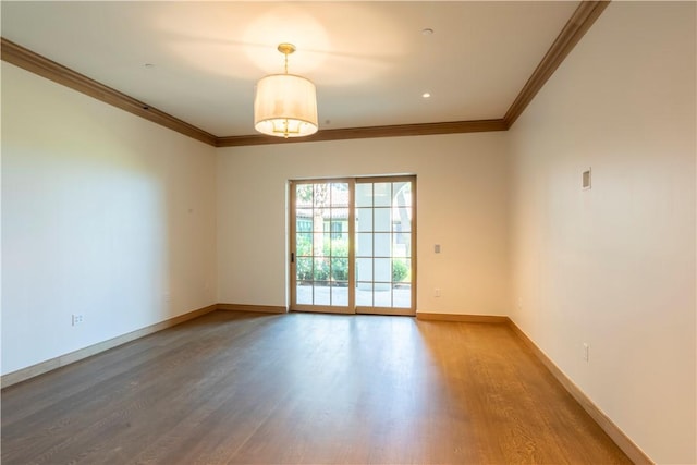 unfurnished room with hardwood / wood-style flooring and ornamental molding