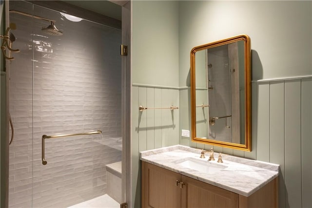 bathroom with vanity and a shower with door