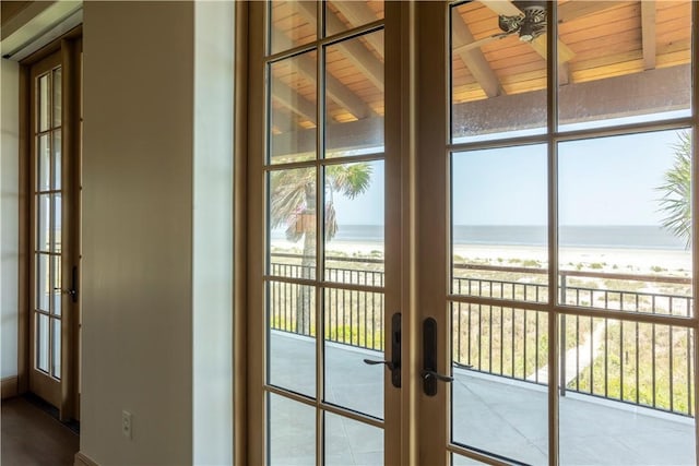 entryway with a water view, ceiling fan, and french doors