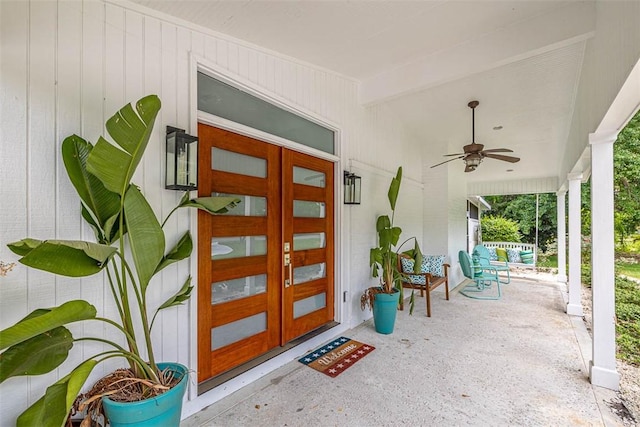 entrance to property with ceiling fan and covered porch