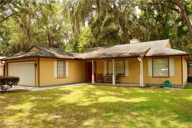 single story home featuring a front yard, a porch, and a garage