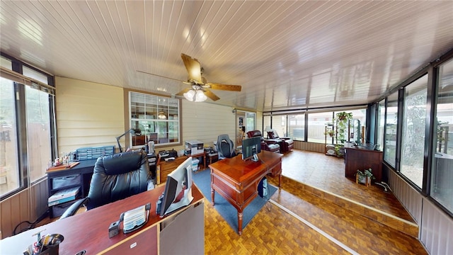 sunroom / solarium featuring ceiling fan, a healthy amount of sunlight, and wood ceiling