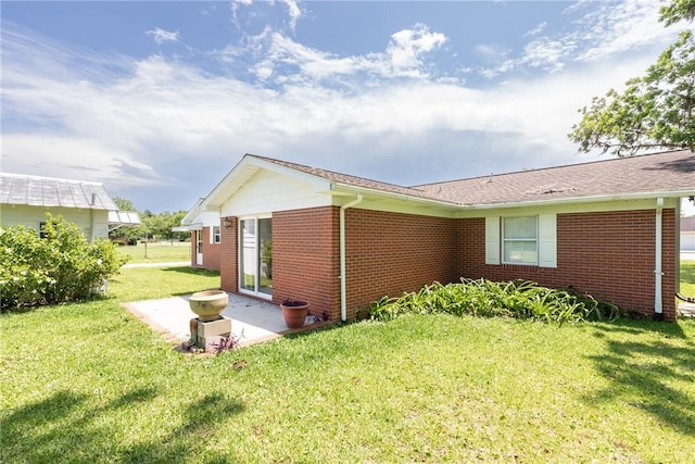 2320 Ben Hill Ave, Waycross, GA 31501 - view of side of home featuring brick siding, a yard, and a patio area