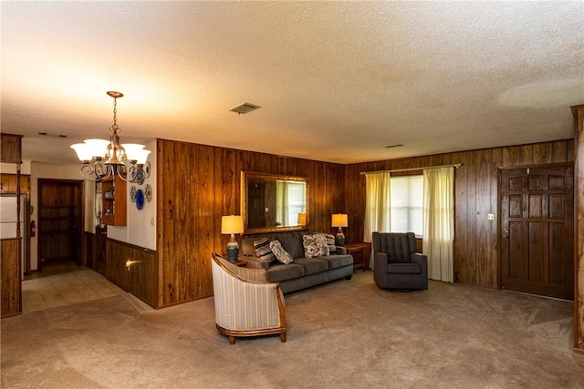2320 Ben Hill Ave, Waycross, GA 31501 - living area with wooden walls, carpet floors, a textured ceiling, and a chandelier
