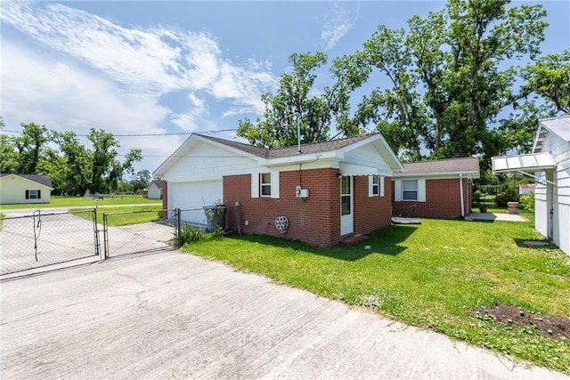 2320 Ben Hill Ave, Waycross, GA 31501 - view of property exterior featuring a gate, brick siding, driveway, and an attached garage