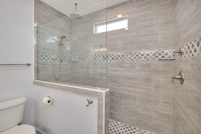 bathroom with walk in shower and toilet