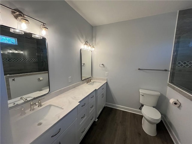 bathroom featuring toilet, vanity, and wood-type flooring