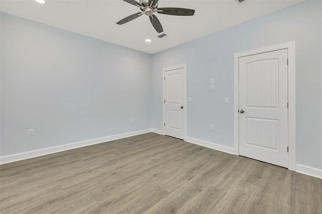 unfurnished room with recessed lighting, ceiling fan, wood finished floors, and baseboards