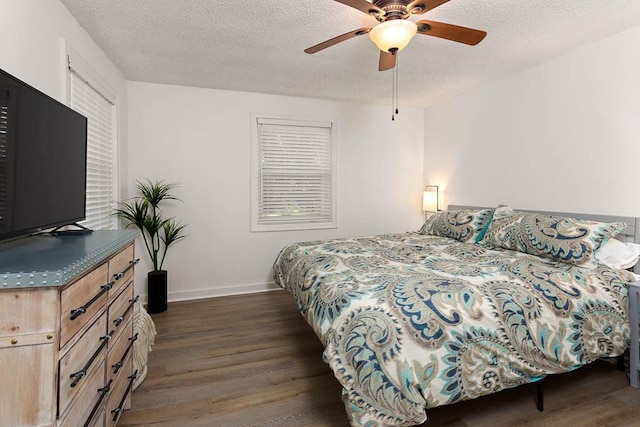 bedroom with dark hardwood / wood-style flooring, a textured ceiling, and ceiling fan