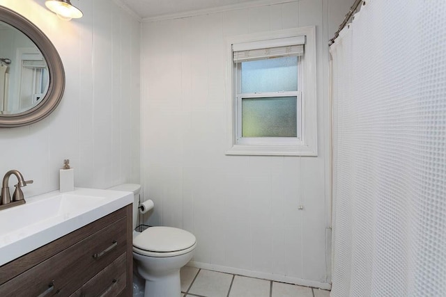 bathroom with tile patterned flooring, vanity, toilet, and wooden walls