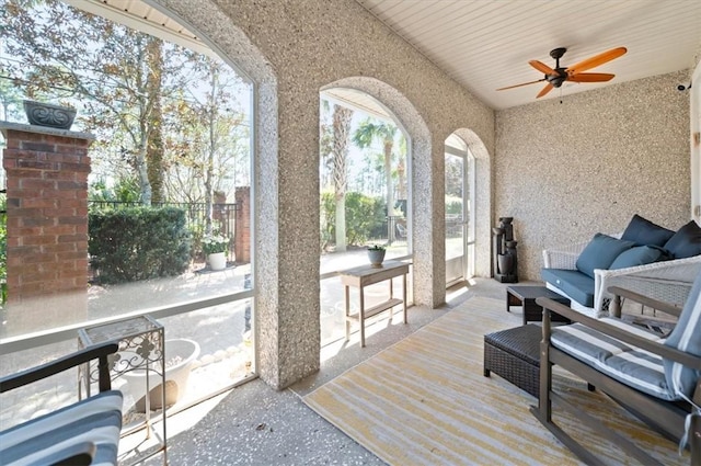 sunroom / solarium featuring a ceiling fan