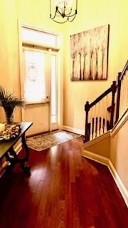 entryway featuring an inviting chandelier and hardwood / wood-style floors