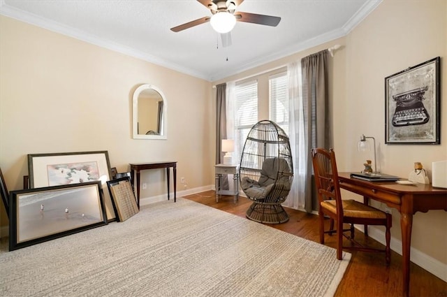 living area featuring baseboards, wood finished floors, and crown molding