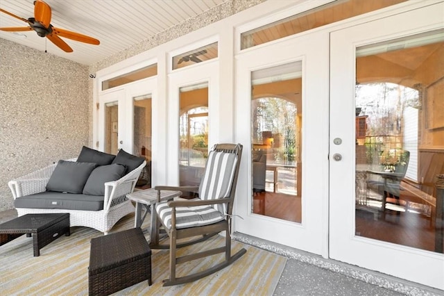 sunroom with a ceiling fan and french doors