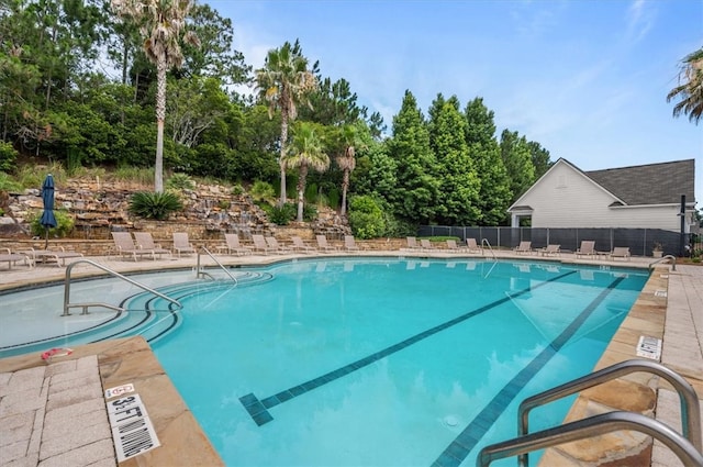 pool featuring a patio area and fence