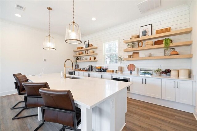 kitchen featuring white cabinets, dark wood-type flooring, open shelves, and a sink