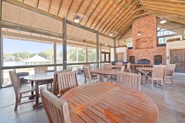 dining space with concrete flooring and high vaulted ceiling