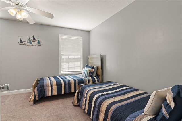 bedroom featuring ceiling fan, carpet floors, and lofted ceiling