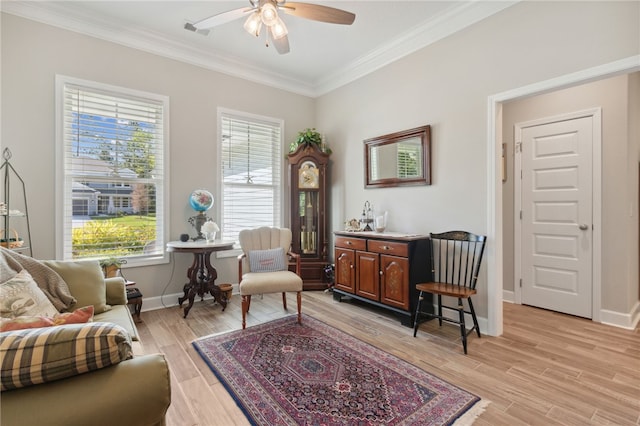 sitting room with ceiling fan, crown molding, and light hardwood / wood-style floors