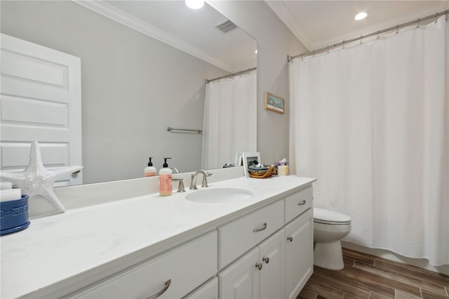 bathroom with hardwood / wood-style floors, vanity, toilet, and ornamental molding