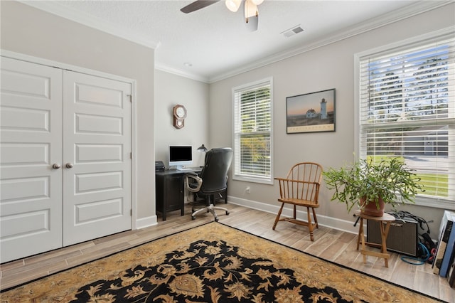 office with light hardwood / wood-style floors, crown molding, ceiling fan, and a healthy amount of sunlight