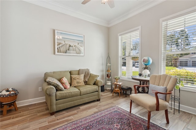 sitting room with crown molding, light hardwood / wood-style flooring, and ceiling fan