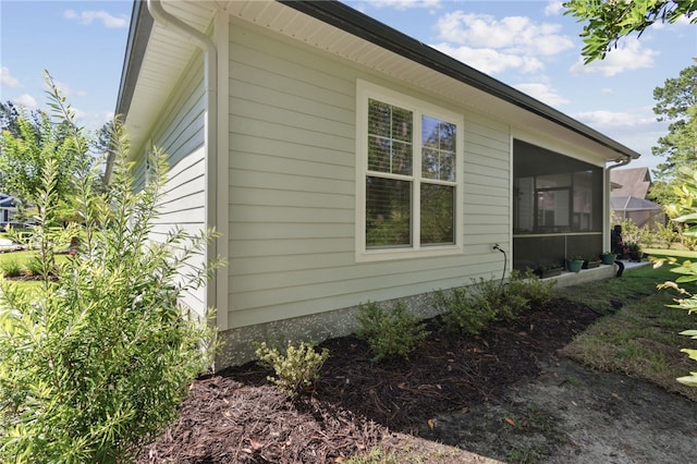 view of property exterior featuring a sunroom