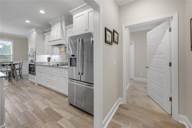 373 Harbour Island Cir, Waverly, GA 31565 - kitchen featuring appliances with stainless steel finishes, white cabinetry, backsplash, light wood-style floors, and recessed lighting
