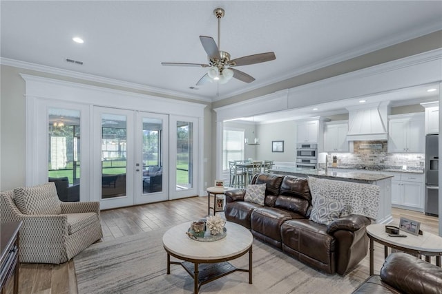 373 Harbour Island Cir, Waverly, GA 31565 - living area with french doors, a ceiling fan, ornamental molding, light wood finished floors, and recessed lighting