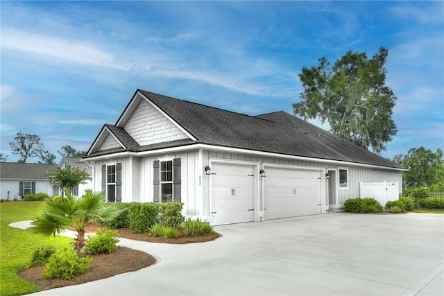 373 Harbour Island Cir, Waverly, GA 31565 - view of property exterior featuring board and batten siding, concrete driveway, an attached garage, and a shingled roof
