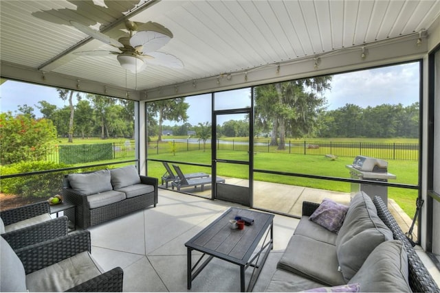 373 Harbour Island Cir, Waverly, GA 31565 - sunroom with outdoor lounge area, a ceiling fan, and view of scattered trees